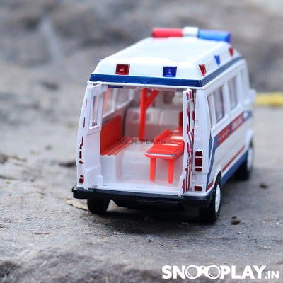 The back side of the plastic made ambulance toy car, white in colour, with a pull back feature.