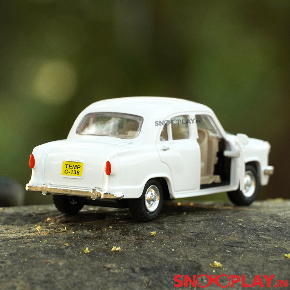 The Ambassador Toy car with openable doors, possessing a sleek white exterior and rolling rubber tyres.