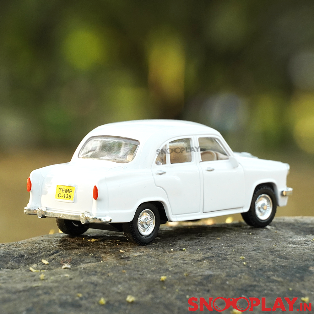 The collectible Ambassador toy car in sleek white exterior, with a pull back feature.