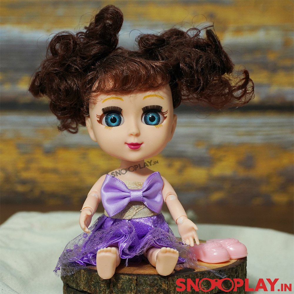 The super cute Doll with blue eyes dressed in purple attire.