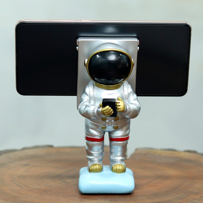 Silver coloured Astronaut mobile phone holder that looks perfect for decor purposes.