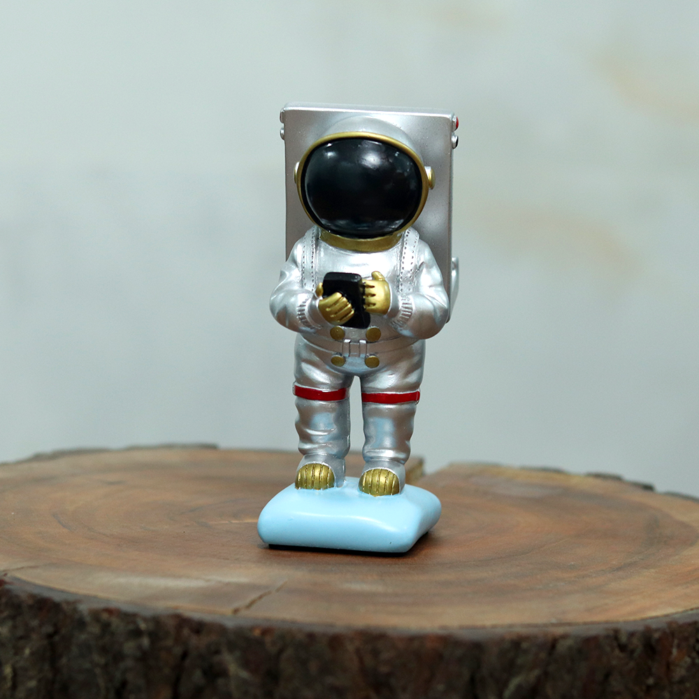 The unique astronaut mobile phone stand made of polyresin with a beautiful colour combination of silver and gold.