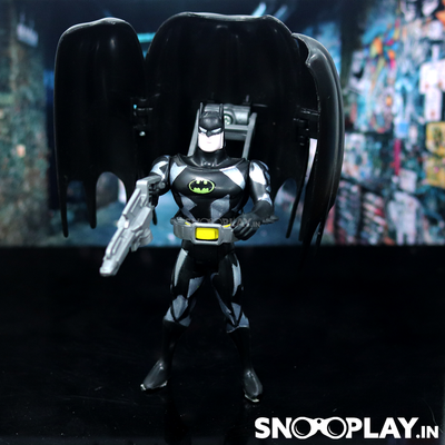 The black clad batman action figure with the cape glider and a silver toy blaster and utility belt.