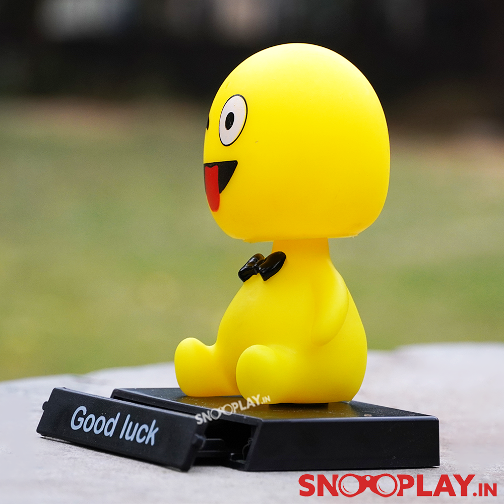 Side view of the yellow coloured wink emoji bobblehead with a bobblehead, perfect for your workstations.