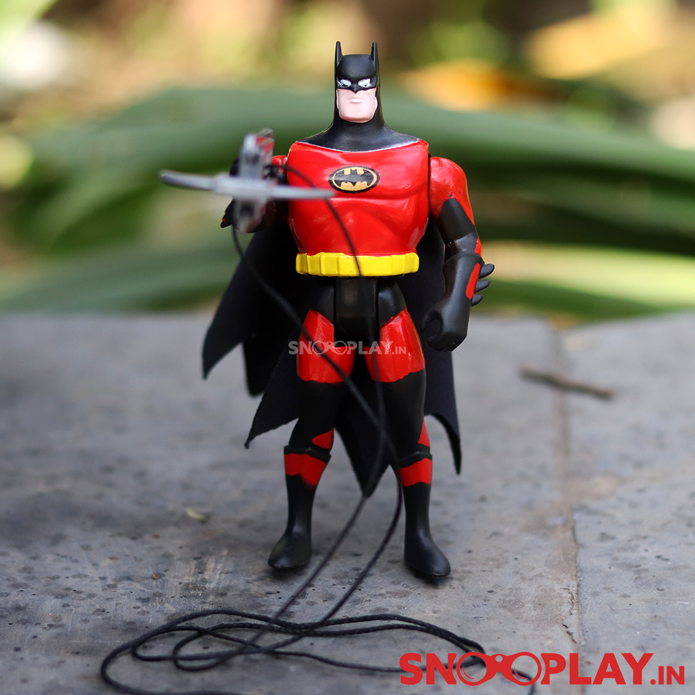 The batman action figure, ready to fight off the criminals, with his rope launcher and body top.
