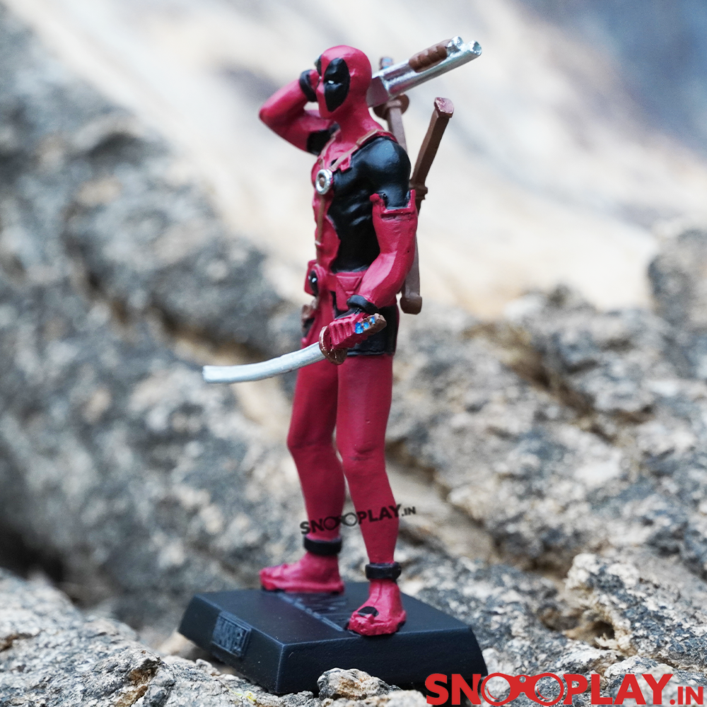 Deadpool action figure, hand painted and made of metallic resin, with a sword and a gun.