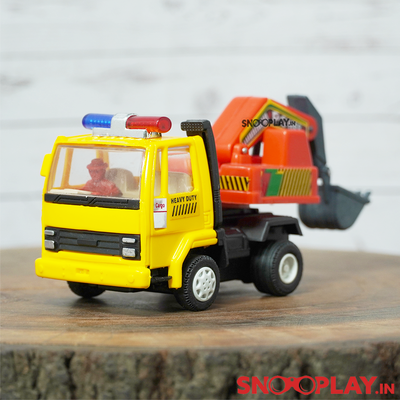 The yellow coloured excavator toy truck with a human figure seated on the driver's seat.