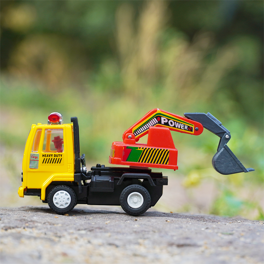The yellow coloured excavator toy truck with a great amount of detailing with red and blue lights.