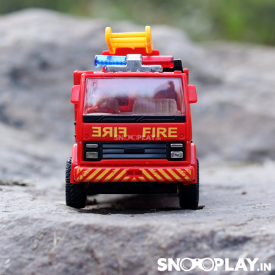 The fire rescue toy truck, red in colour, with a yellow ladder and a fireman sitting in the front.