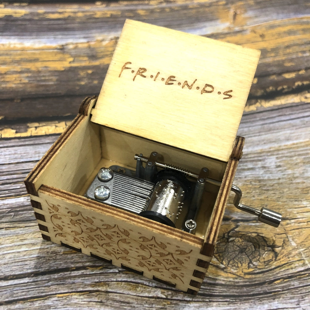 Beautifully carved surface of the wooden musical box that plays Friends TV show theme song.