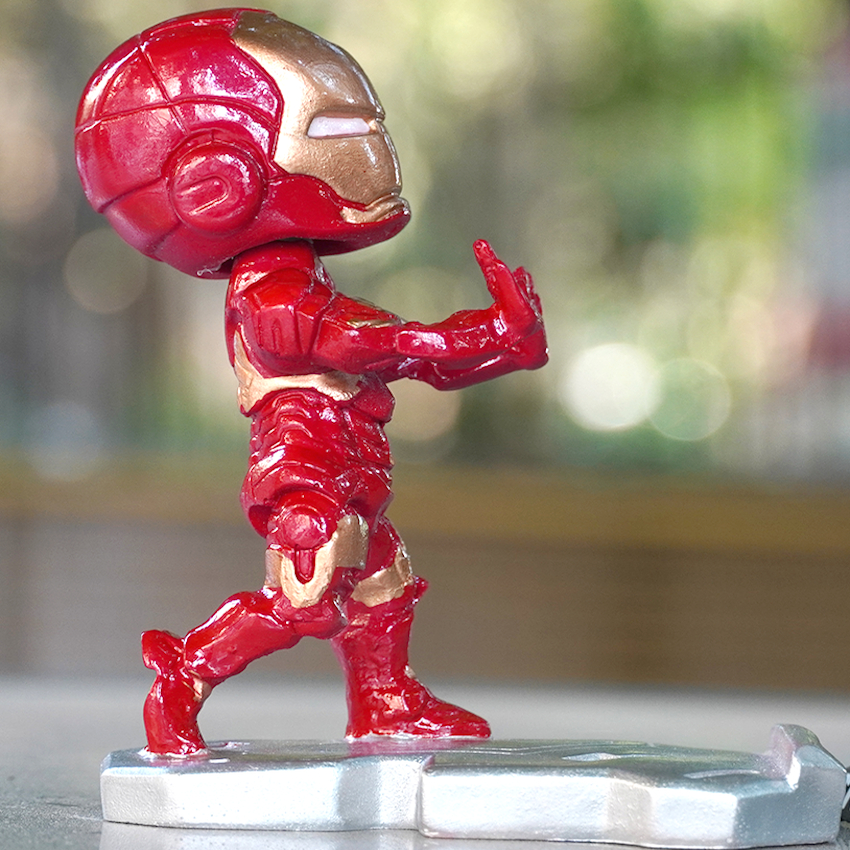 Iron Man bobblehead, signifying strength and durability, with his powered armour suit, and a phone holder.