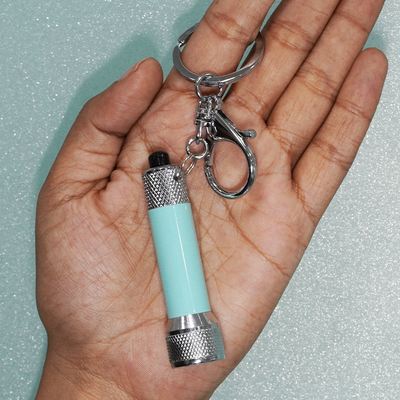The blue coloured Torch keychain (flashlight) with lobster clasp hook, perfect gift for those who travel a lot.