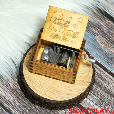 Hand engraved wooden box that plays Twinkle Twinkle Little star on turning the hand crank.